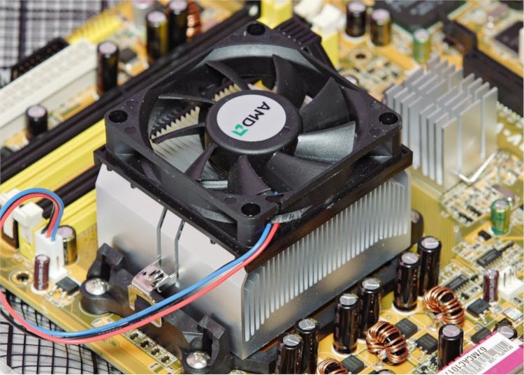 A standard CPU resting below a heatsink and fan