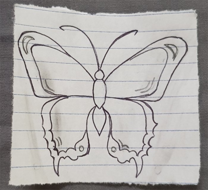A pen sketch of the final butterfly outline, using a wider body, sharper bottom edges, and a dot on the bottom of each wing