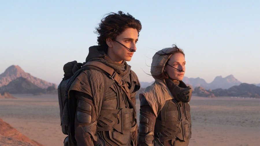 Paul and Jessica on a sand dune with stillsuits and sinus condensers