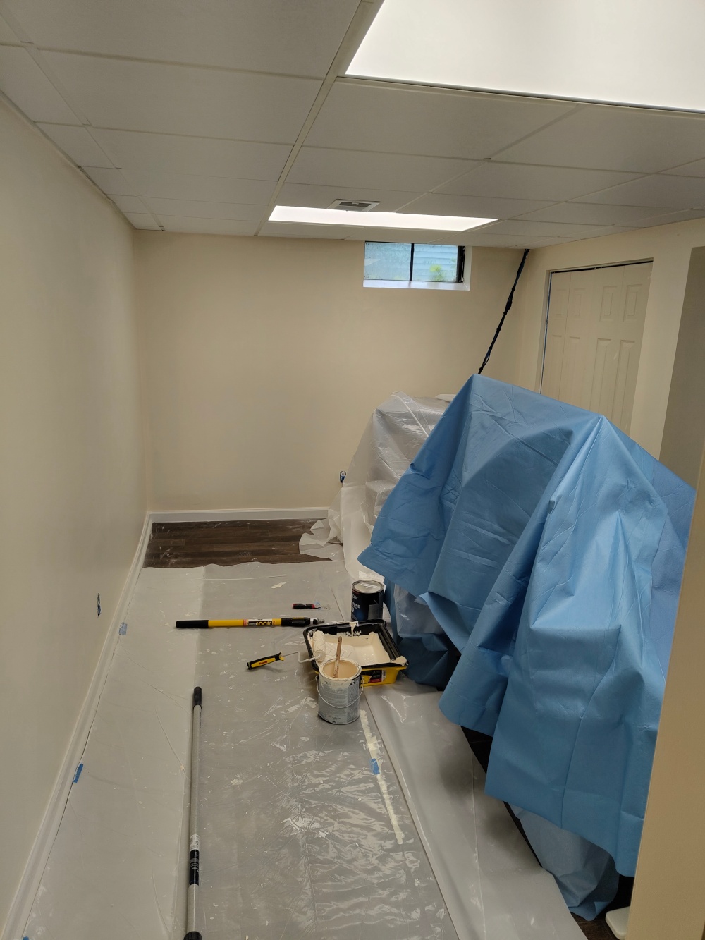 A picture of my home office with painted walls. The first coat isn't perfectly covering the walls but that is to be expected.