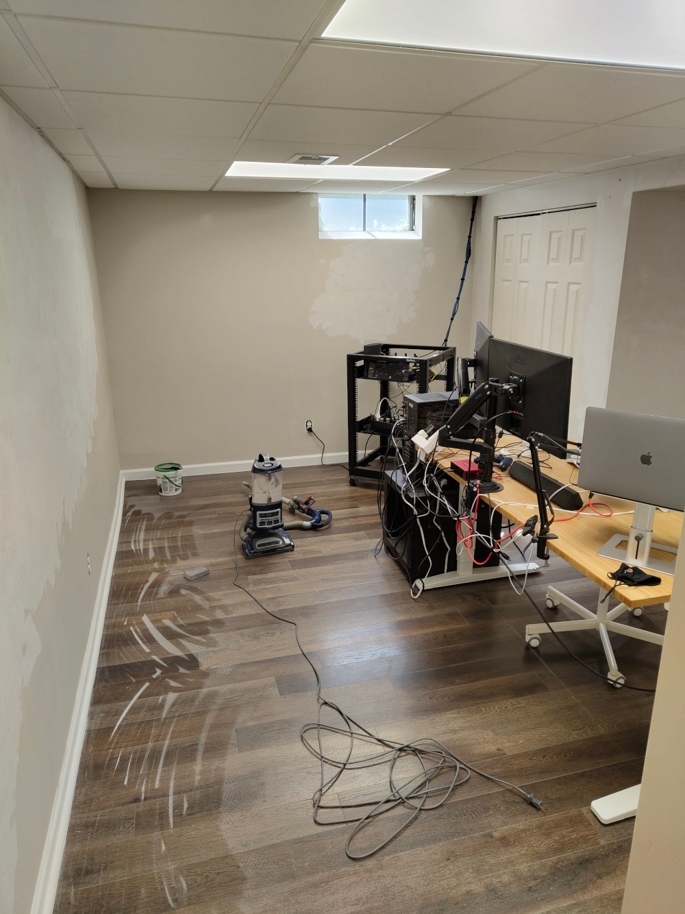 A picture of my home office with repaired and cleaned walls. Dust still cakes the floor.