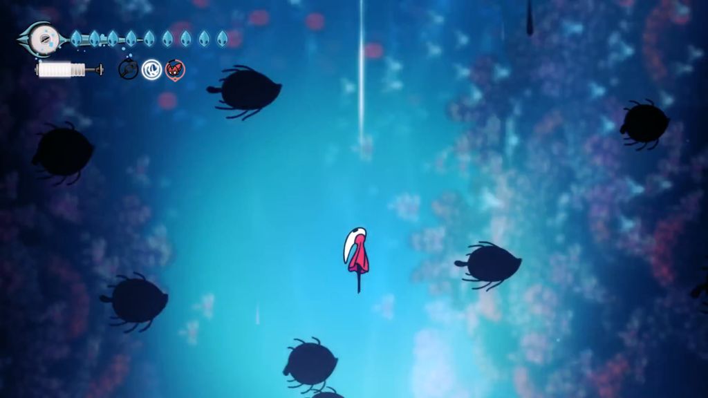 Hornet ascends an underwater column filled with fish swimming across the screen and coral growing on the edges.