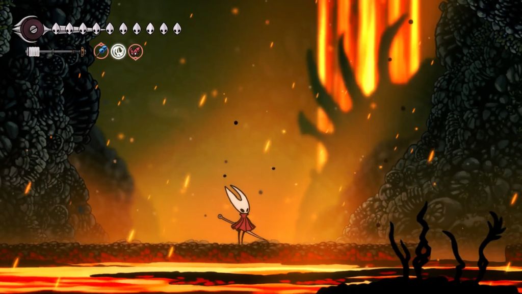 Molten lava flows on the floor and pours from the ceiling around volcanic rock faces and hardened rock platforms.